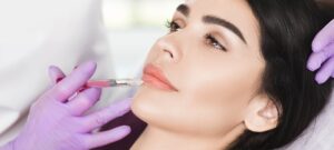 woman having lip injections, procedure lip augmentationwoman having lip injections, a prick of a
